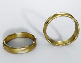 a pair of gold rings sitting next to each other